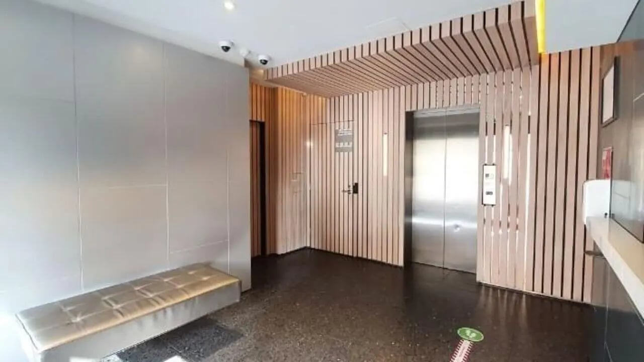 Elevator lobby with bench and wooden paneling reception area at Student Living On Campus in Melbourne Student Accommodation
