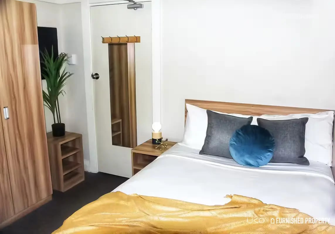 Bed wardrobe plant and mirror bedroom at ume Potts Point in Sydney Student Accommodation