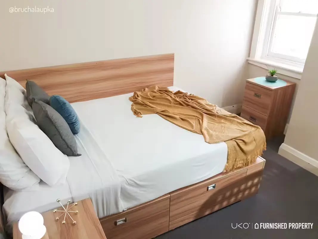 Bed with drawers pillows blanket nightstand bedroom at ume Potts Point in Sydney Student Accommodation