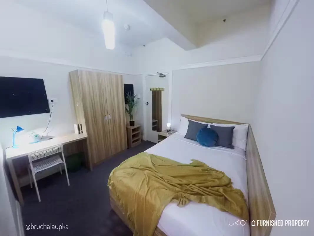 Bed wardrobe desk television and chair bedroom at ume Potts Point in Sydney Student Accommodation
