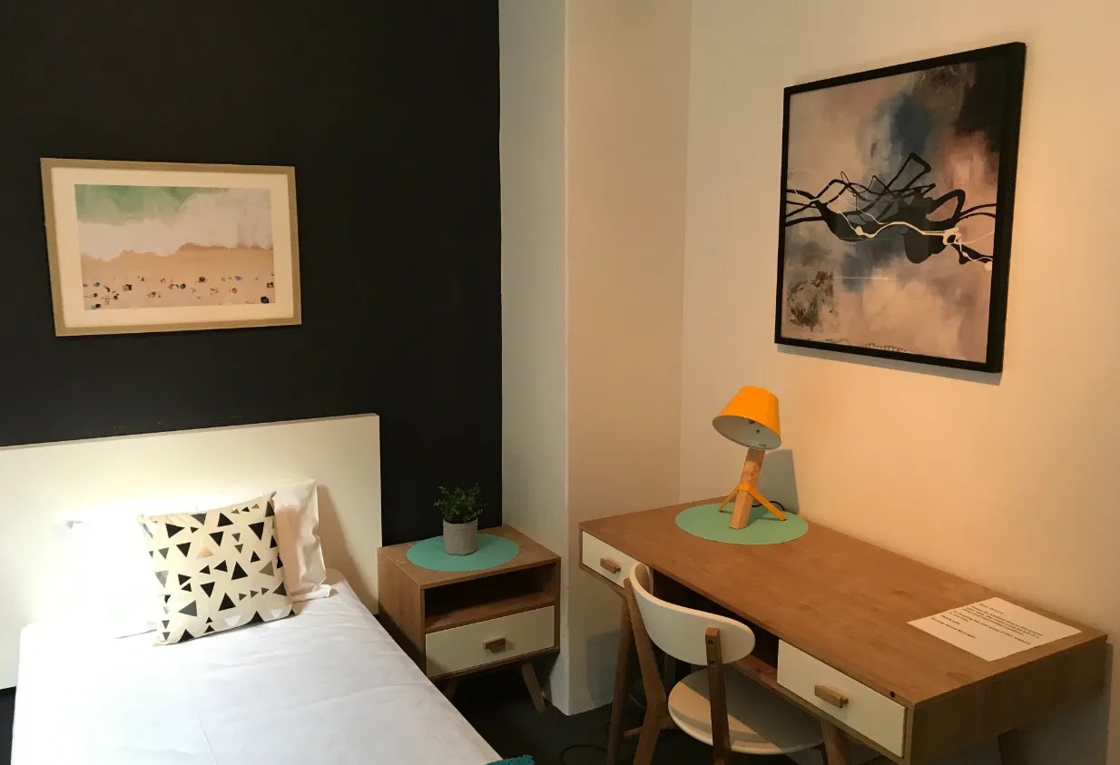 Single bed desk lamp artwork bedside table bedroom at ume Hyde Park in Sydney Student Accommodation