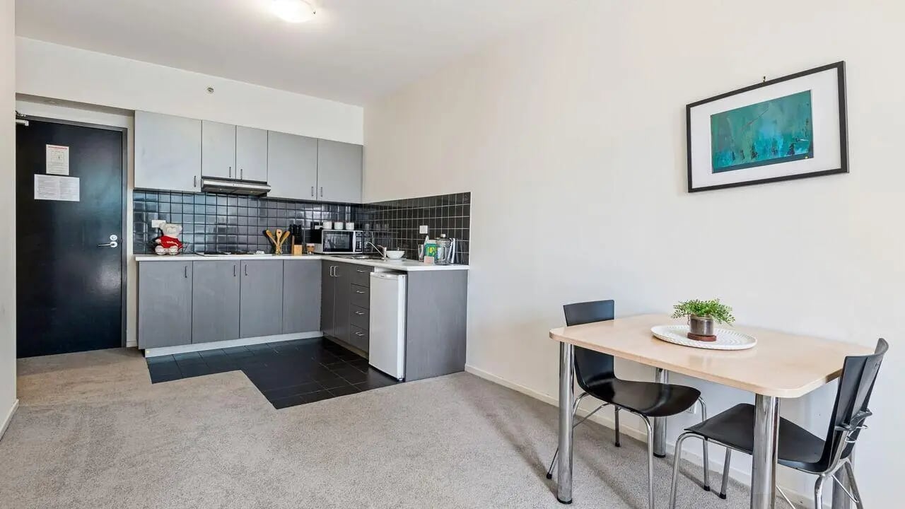 Kitchen with dining table and chairs living area at Student Living on Lonsdale in Melbourne Student Accommodation