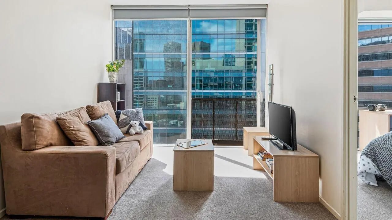 Brown sofa television and coffee table living room at Student Living on Lonsdale in Melbourne Student Accommodation
