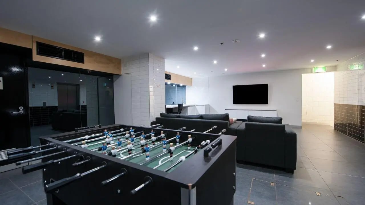 Foosball table sofas television communal room at Student Living on Lonsdale in Melbourne Student Accommodation