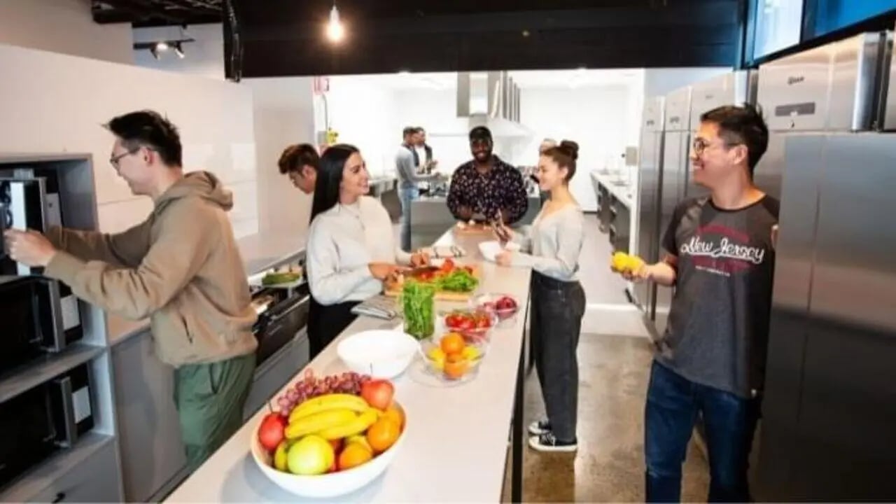Students preparing food at communal kitchen counter kitchen at UniLodge Carlton in Melbourne Student Accommodation