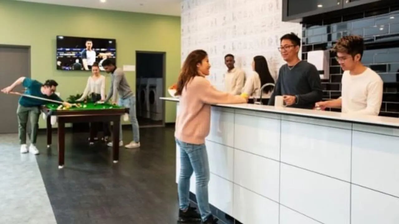 Students playing pool by the kitchen area at UniLodge Carlton in Melbourne Student Accommodation
