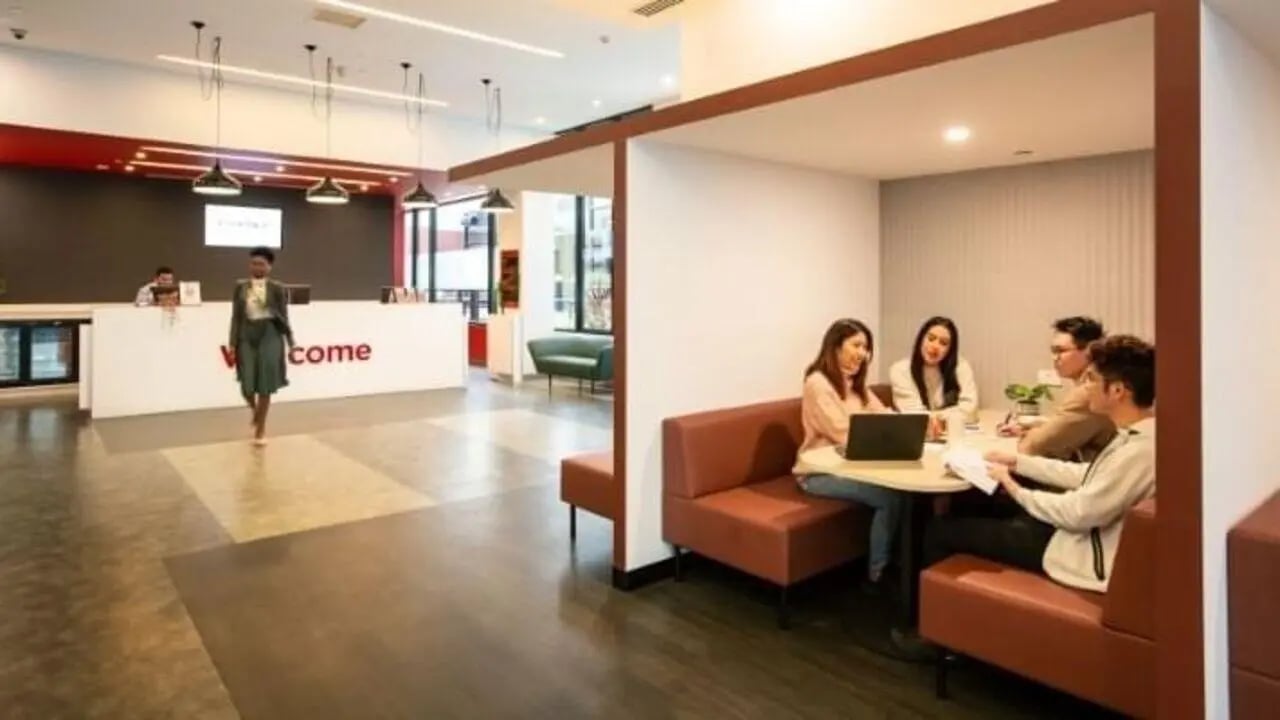 Reception desk with staff and students studying Living Room at UniLodge Carlton in Melbourne Student Accommodation