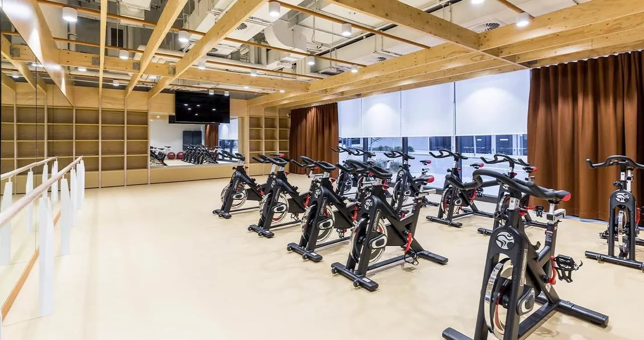 Spinning bikes in gym with ballet barre Gym at Iglu Central in Sydney Student Accommodation
