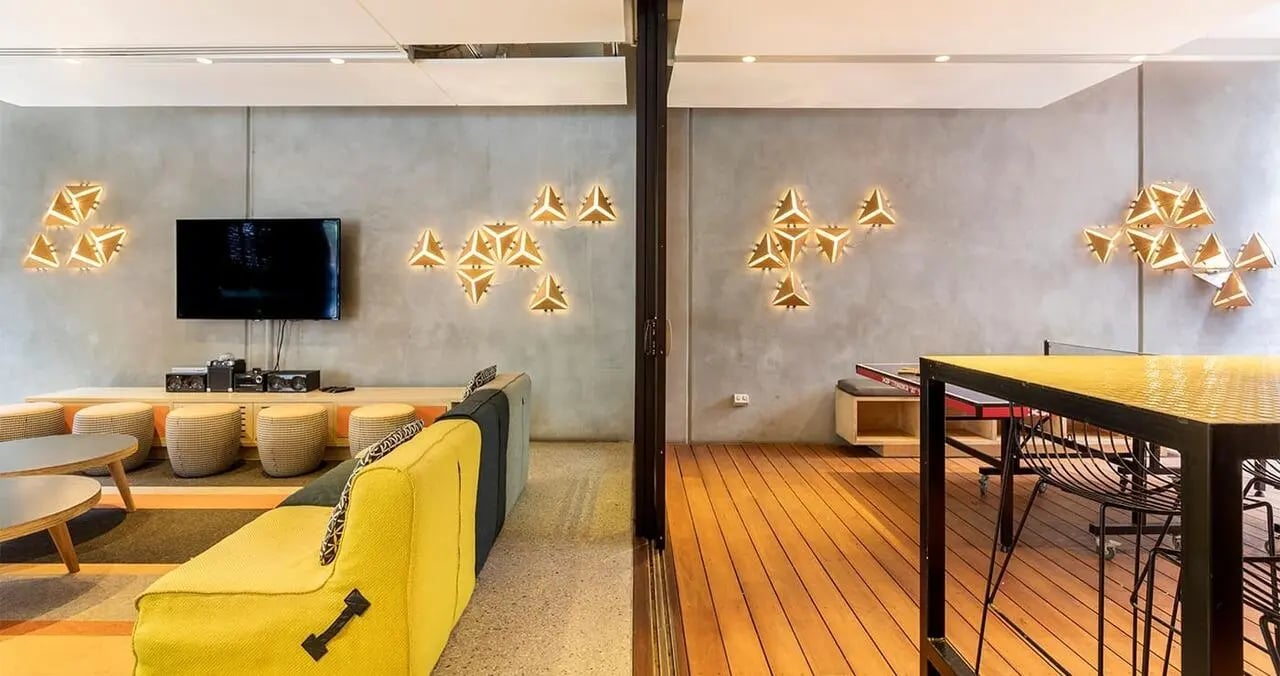 Sofa ping pong table tv geometric lights lounge at Iglu Central in Sydney Student Accommodation