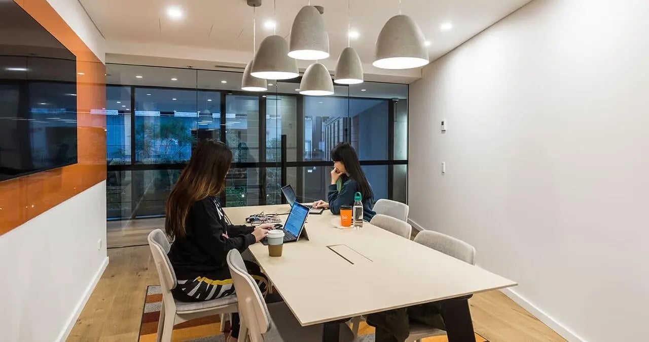 Two students working at table study area at Iglu Chatswood in Sydney Student Accommodation