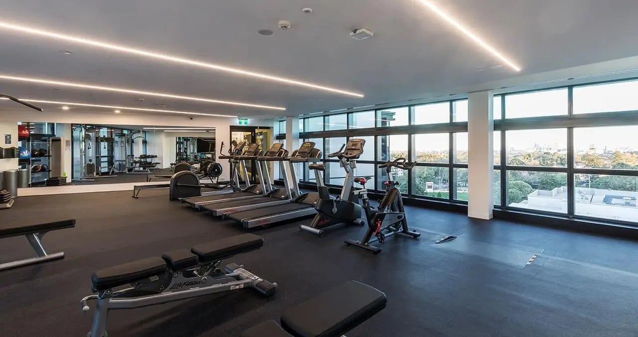 Treadmills exercise bikes weight benches gym area at Iglu Chatswood in Sydney Student Accommodation