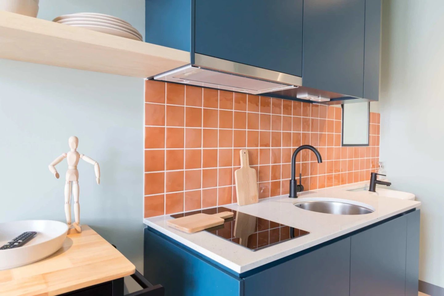 Modern blue cabinets sink and induction hob kitchen at UKO Marrickville Village in Sydney Student Accommodation