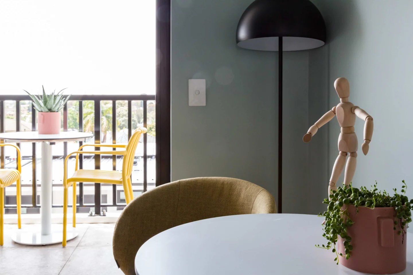 Balcony table chairs plants and mannequin living area at UKO Marrickville Village in Sydney Student Accommodation