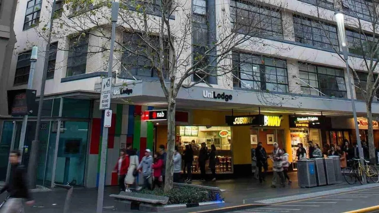 UniLodge exterior with street level shops and pedestrians exterior at Student Living-339 Swanston in Melbourne Student Accommodation