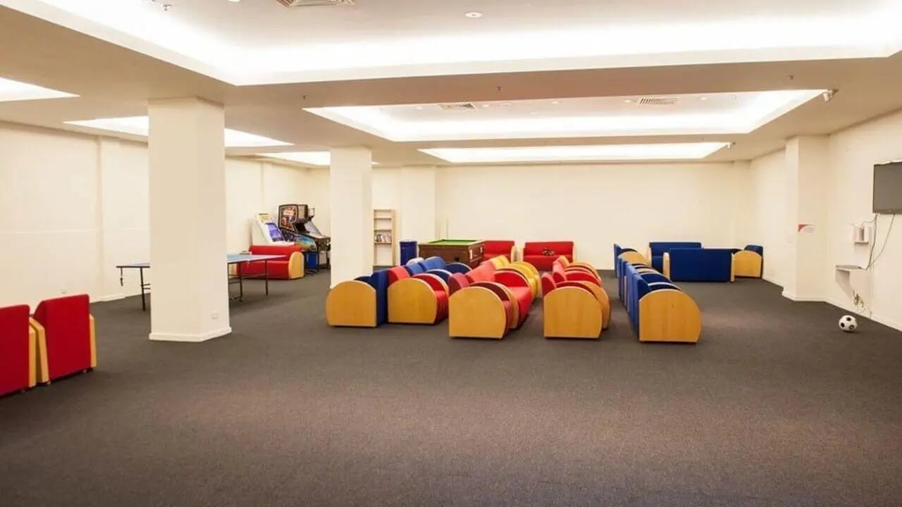 Arcade machines pool table sofas lounge area at Student Living - 570 Lygon in Melbourne Student Accommodation