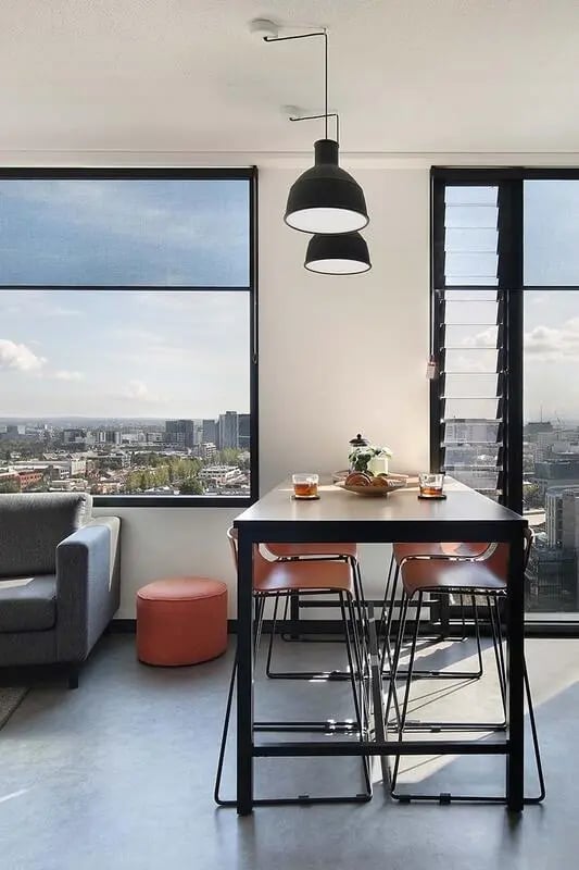 Table with chairs and sofa dining area at Iglu Melbourne City in Melbourne Student Accommodation