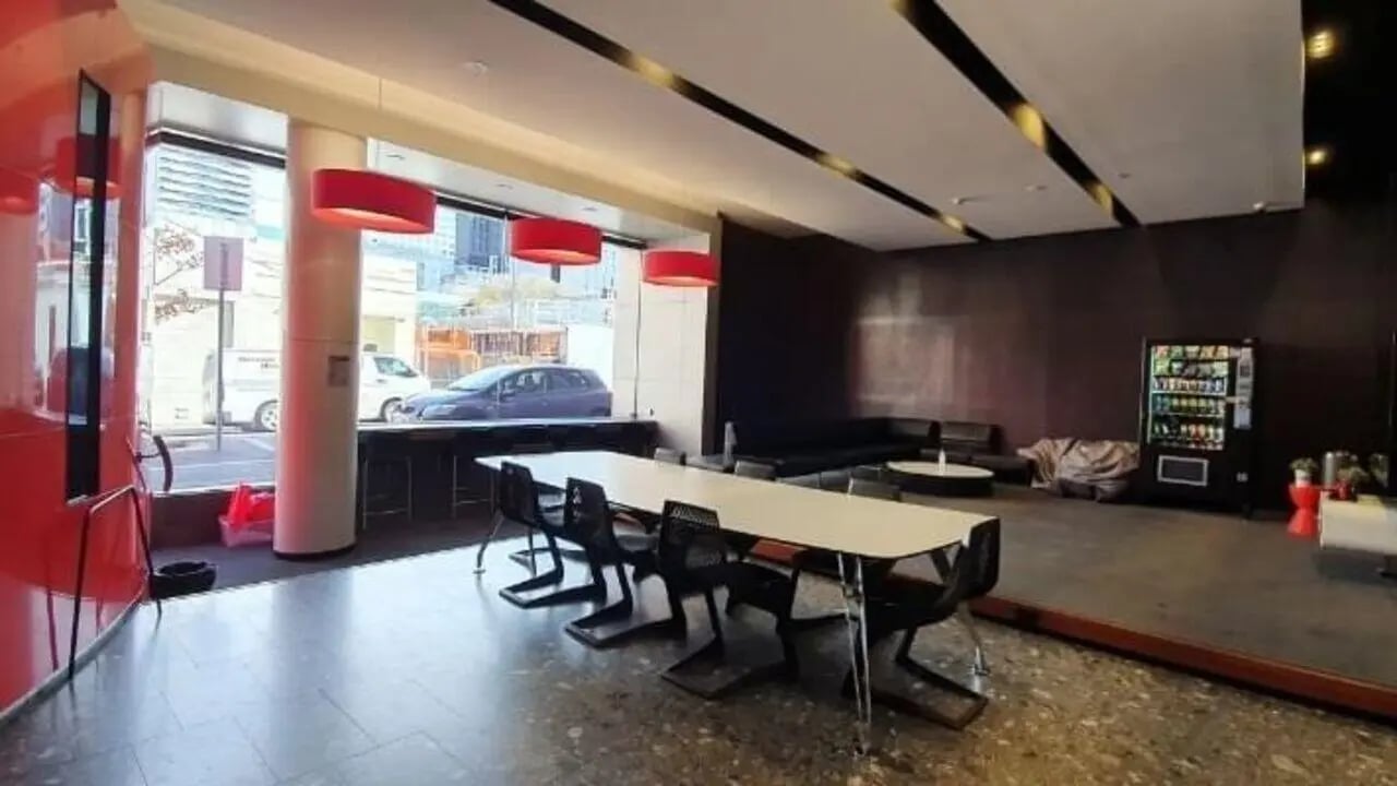 Long table chairs vending machine lounge living room at Student Living D2 in Melbourne Student Accommodation