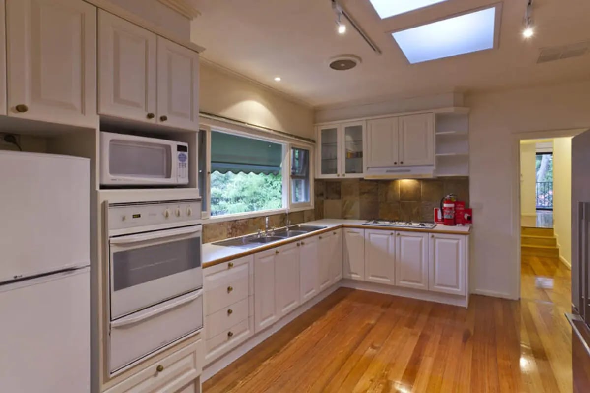 White kitchen with oven microwave fridge and cabinets kitchen at Park Lane House in Melbourne Student Accommodation