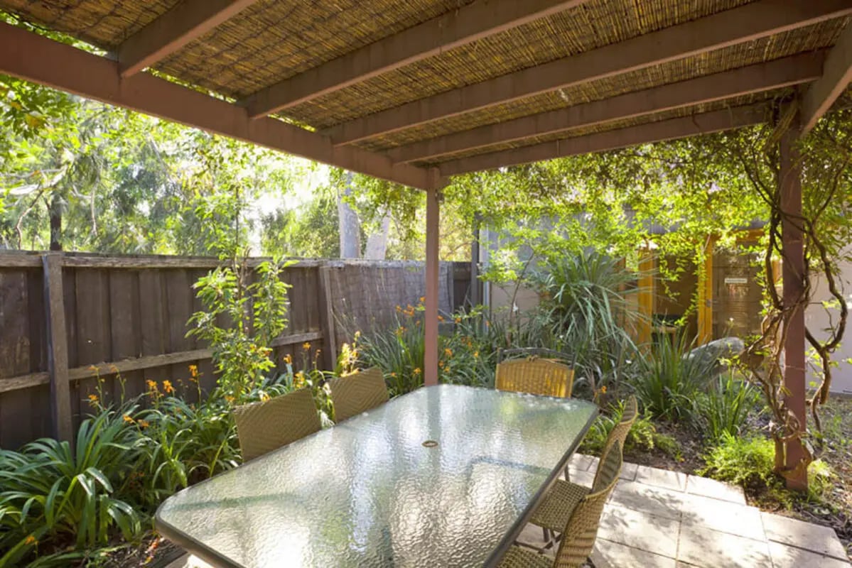Glass table and chairs covered patio patio area at Park Lane House in Melbourne Student Accommodation