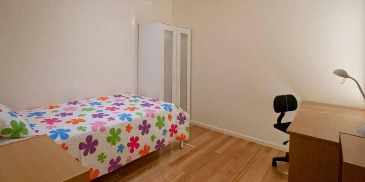 Bed desk chair closet bedroom at Sunset House in Melbourne Student Accommodation