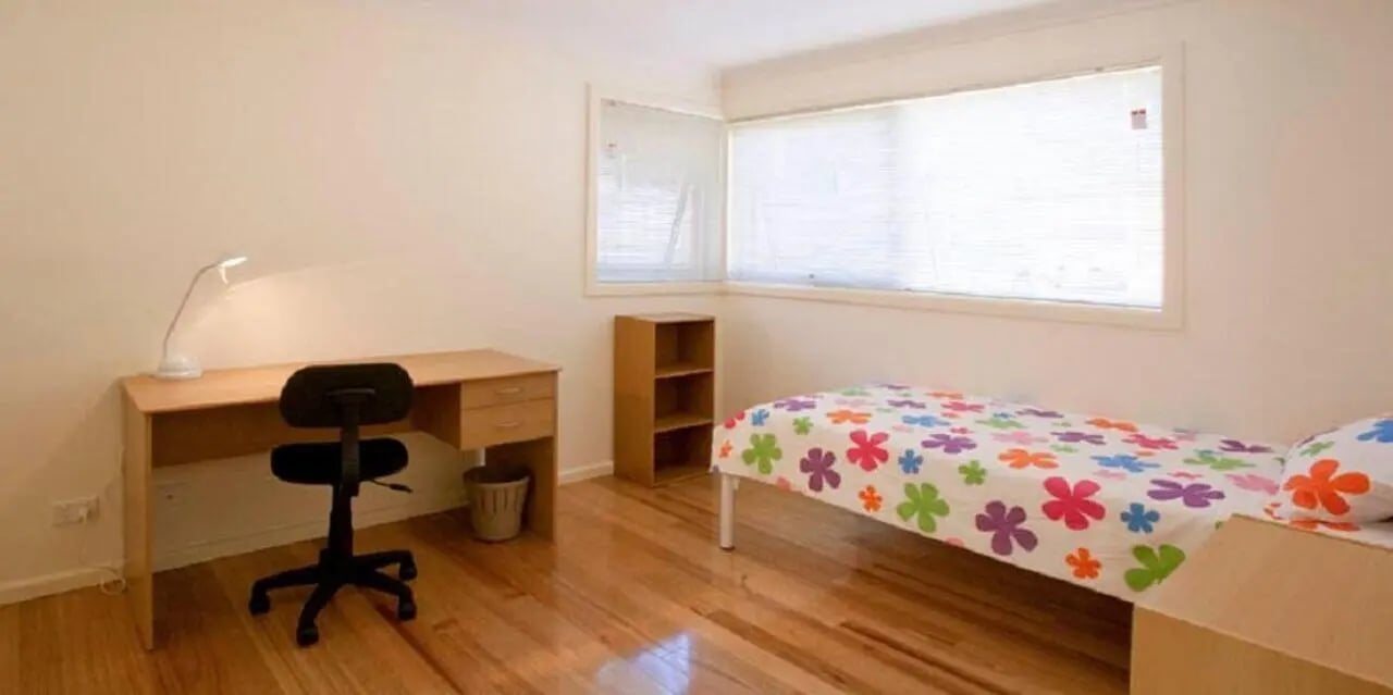 Desk chair lamp and bed bedroom at Sunset House in Melbourne Student Accommodation