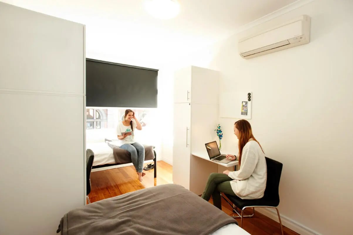 Two students study and relax in bedroom at Link2 Broadway in Sydney Student Accommodation