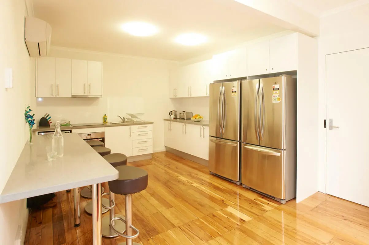 Counter stools fridges cabinets and sink kitchen at Link2 Broadway in Sydney Student Accommodation