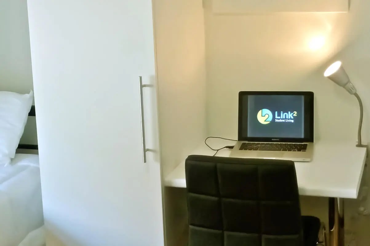 White wardrobe laptop desk chair study area at Link2 Broadway in Sydney Student Accommodation