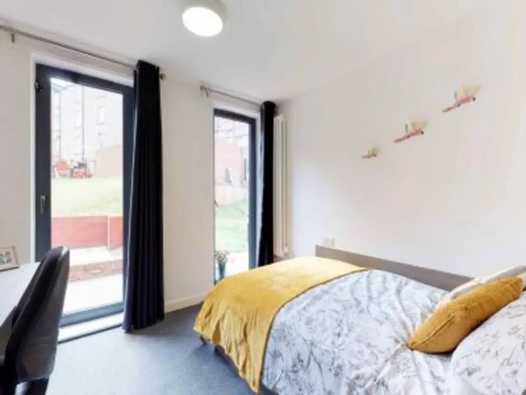 Bed desk and double doors bedroom. at Haymarket Edinburgh in Edinburgh Student Accommodation