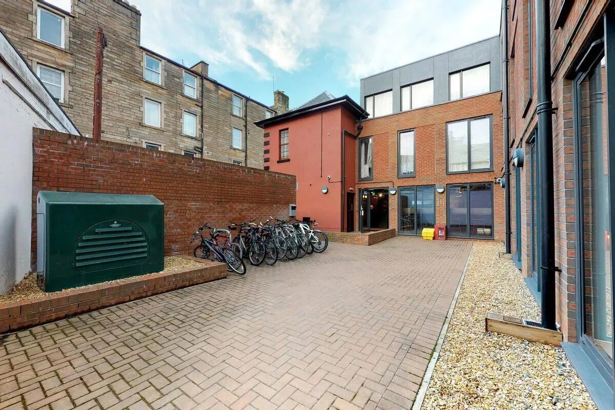 Bicycles parked beside brick building exterior at Haymarket Edinburgh in Edinburgh Student Accommodation