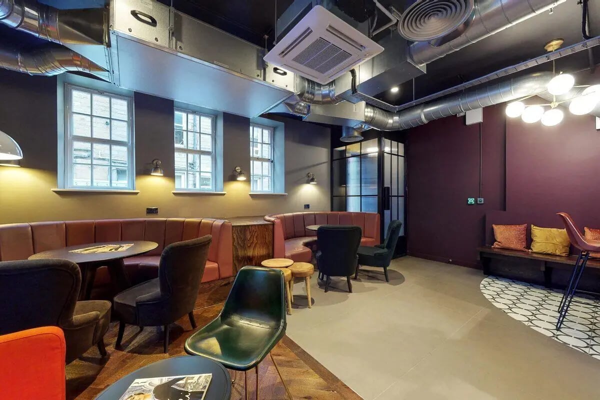 Booth seating tables chairs and a bench common area at Haymarket Edinburgh in Edinburgh Student Accommodation