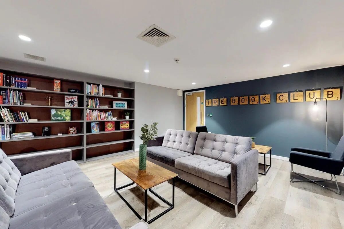 Sofas coffee table bookshelves artwork communal area at St James Glasgow in Glasgow Student Accommodation