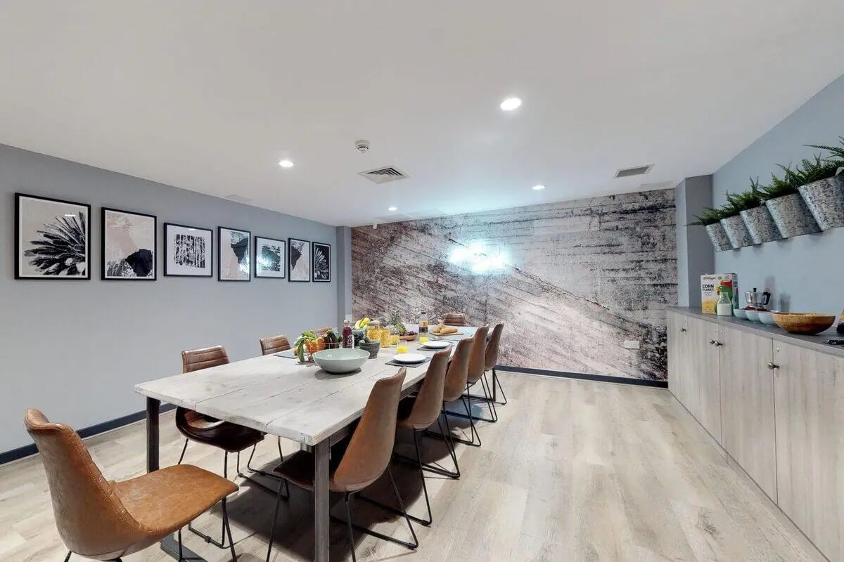 Dining table with chairs and food kitchen counter at St James Glasgow in Glasgow Student Accommodation