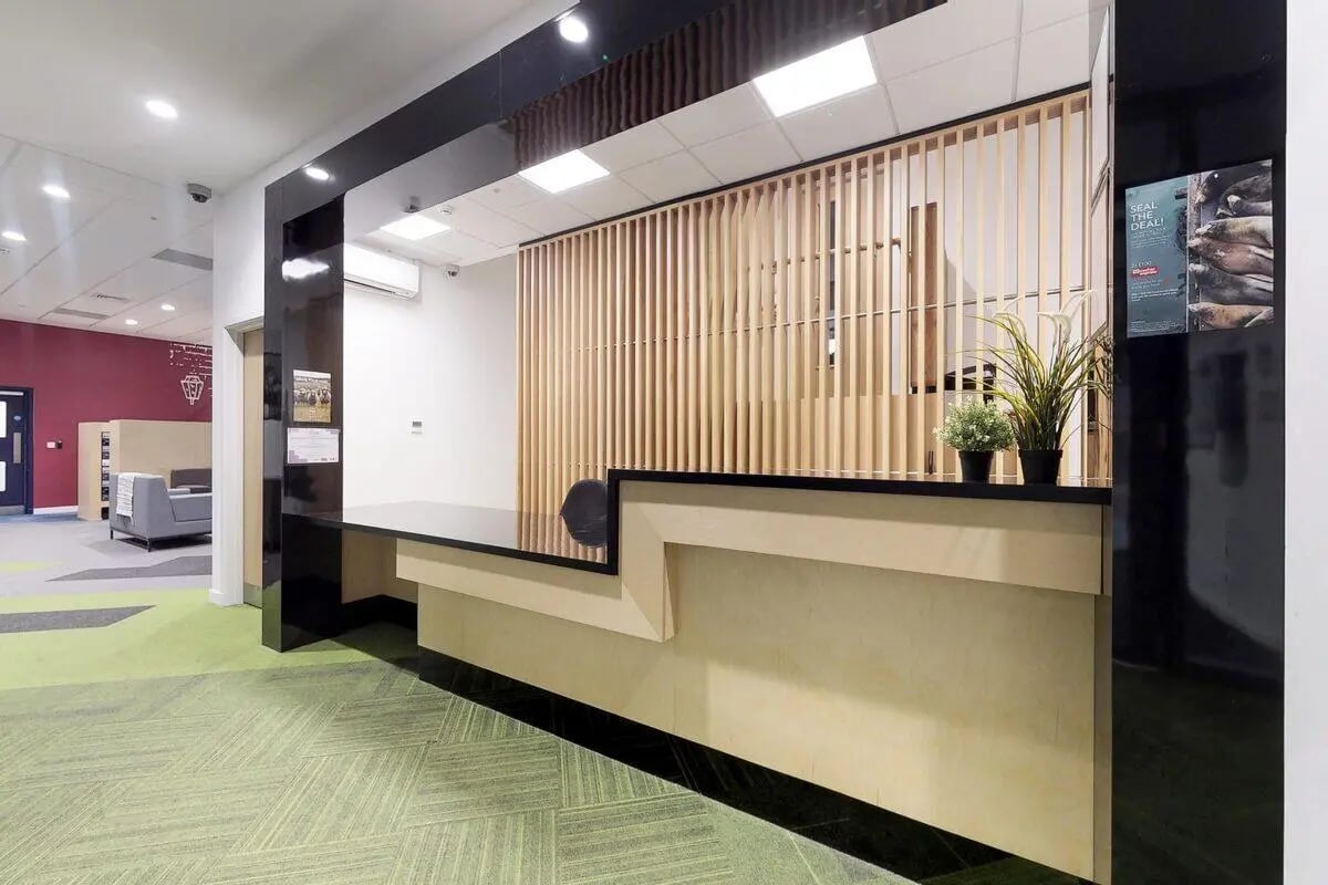 Reception desk plants and wooden screen interior at St James Glasgow in Glasgow Student Accommodation
