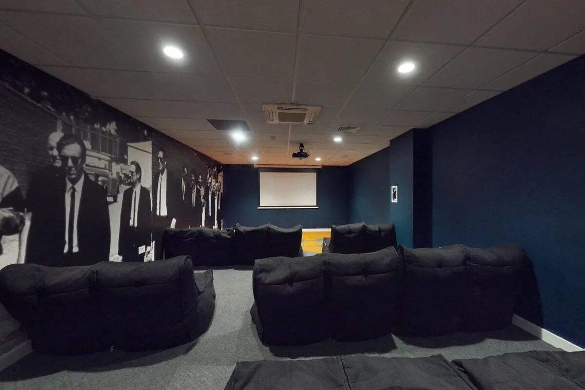 Beanbags with movie screen and mural Cinema Room at St James Glasgow in Glasgow Student Accommodation