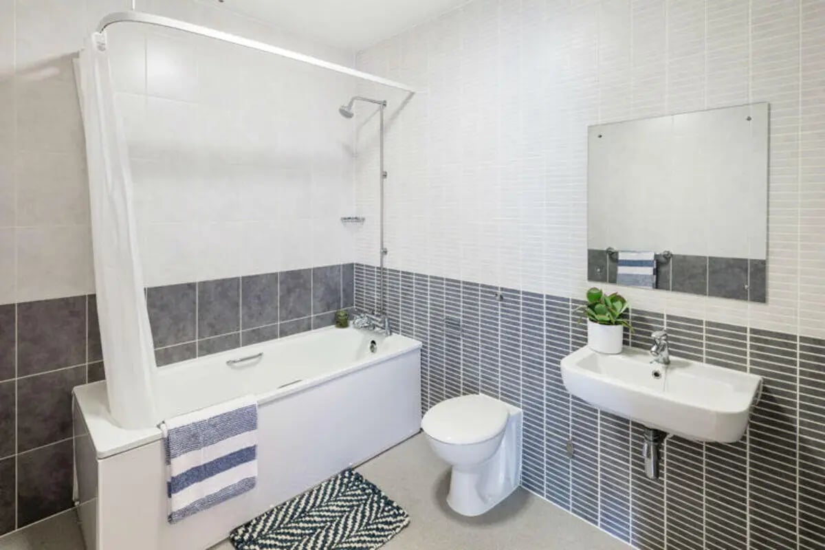 Modern bathroom with bathtub toilet sink and mirror Bathroom at Metchley Hall in Birmingham Student Accommodation