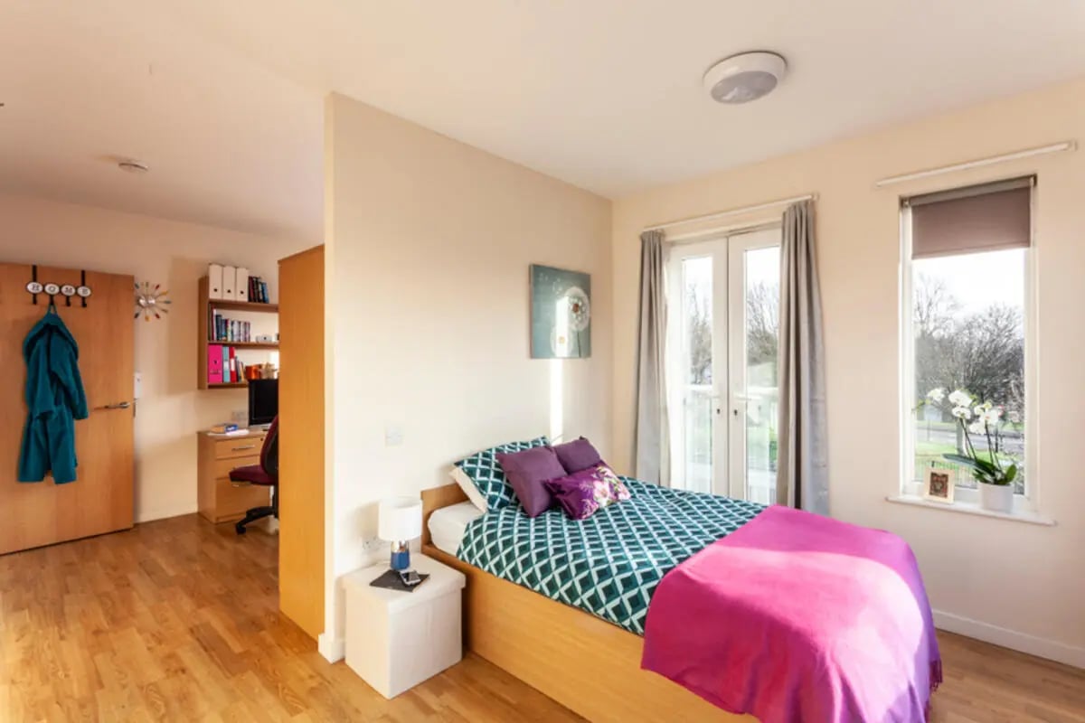 Bed with teal and white pattern duvet bedroom at Metchley Hall in Birmingham Student Accommodation