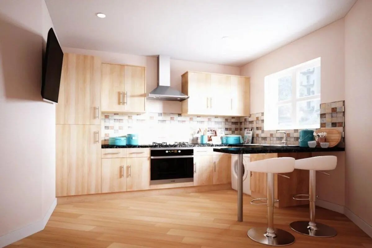 Light wood cabinets stove bar stools breakfast bar kitchen at City Edge - Manchester in Manchester Student Accommodation