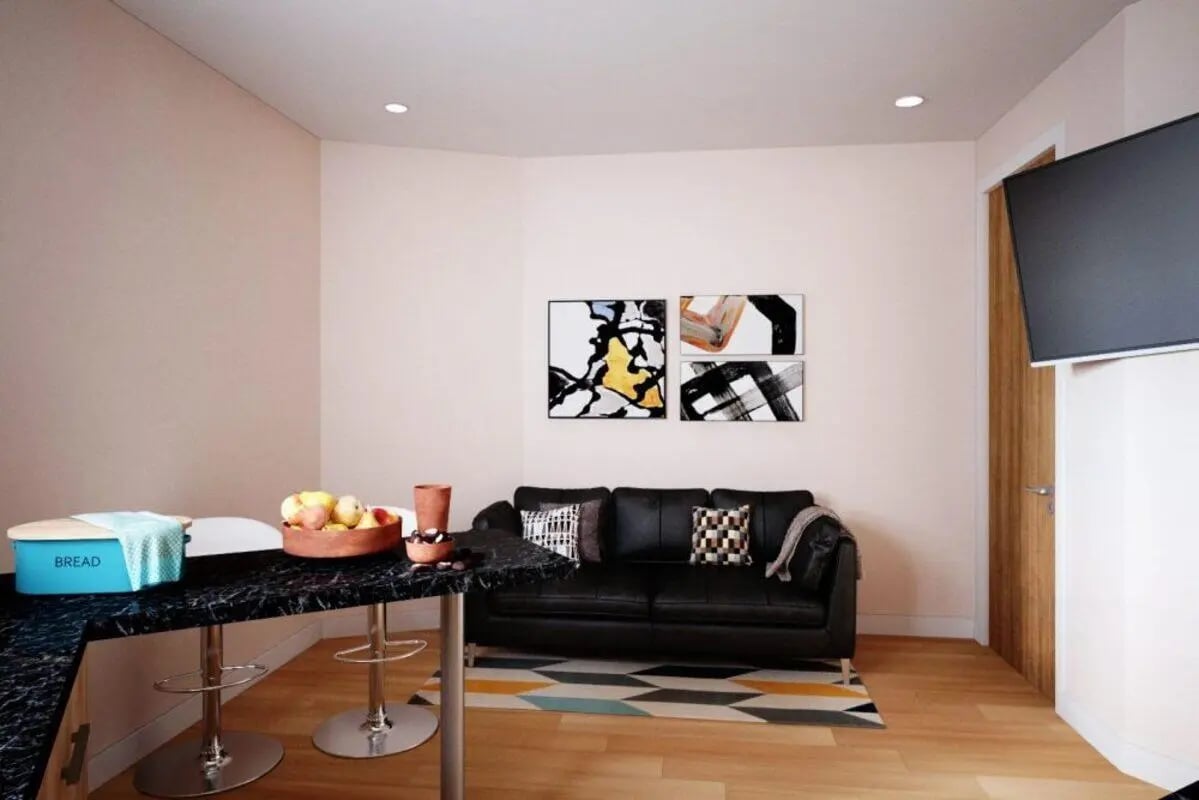 Black sofa bar table art and fruit living room at City Edge - Manchester in Manchester Student Accommodation