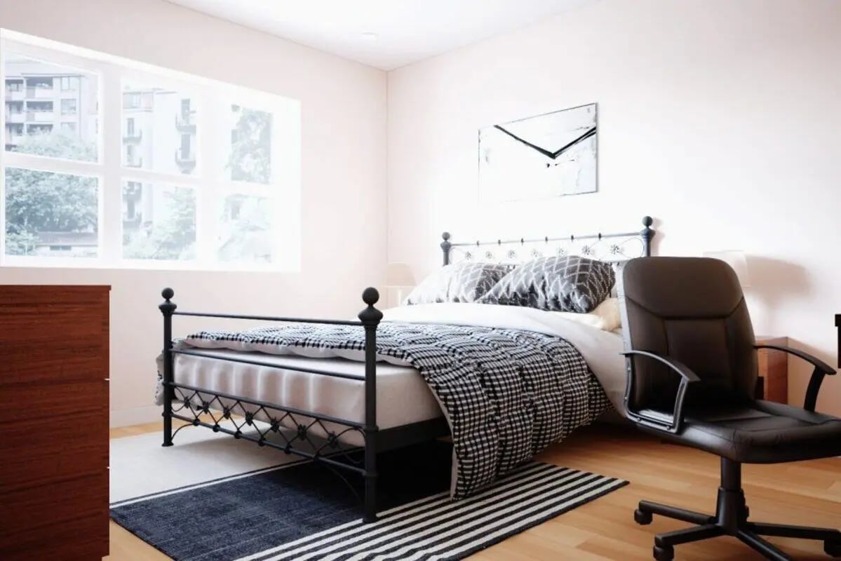 Black metal bed with patterned bedding office chair bedroom at City Edge - Manchester in Manchester Student Accommodation