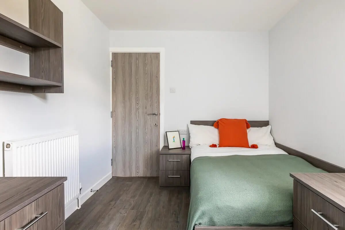 Bed nightstand door shelves radiator bedroom at Hyde Park in Leeds Student Accommodation