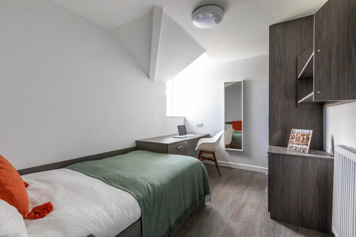 Bed desk laptop chair mirror wardrobe bedroom at Hyde Park in Leeds Student Accommodation