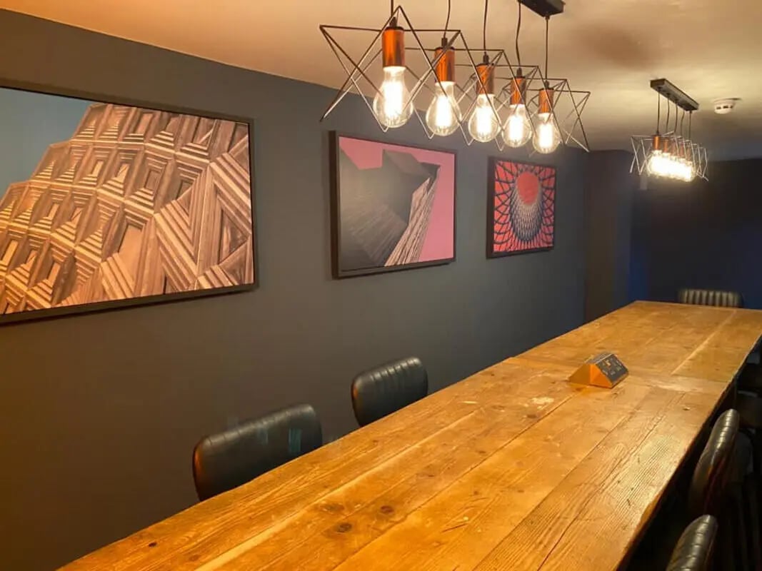 Large wooden table with chairs and art study area at Hyde Park in Leeds Student Accommodation