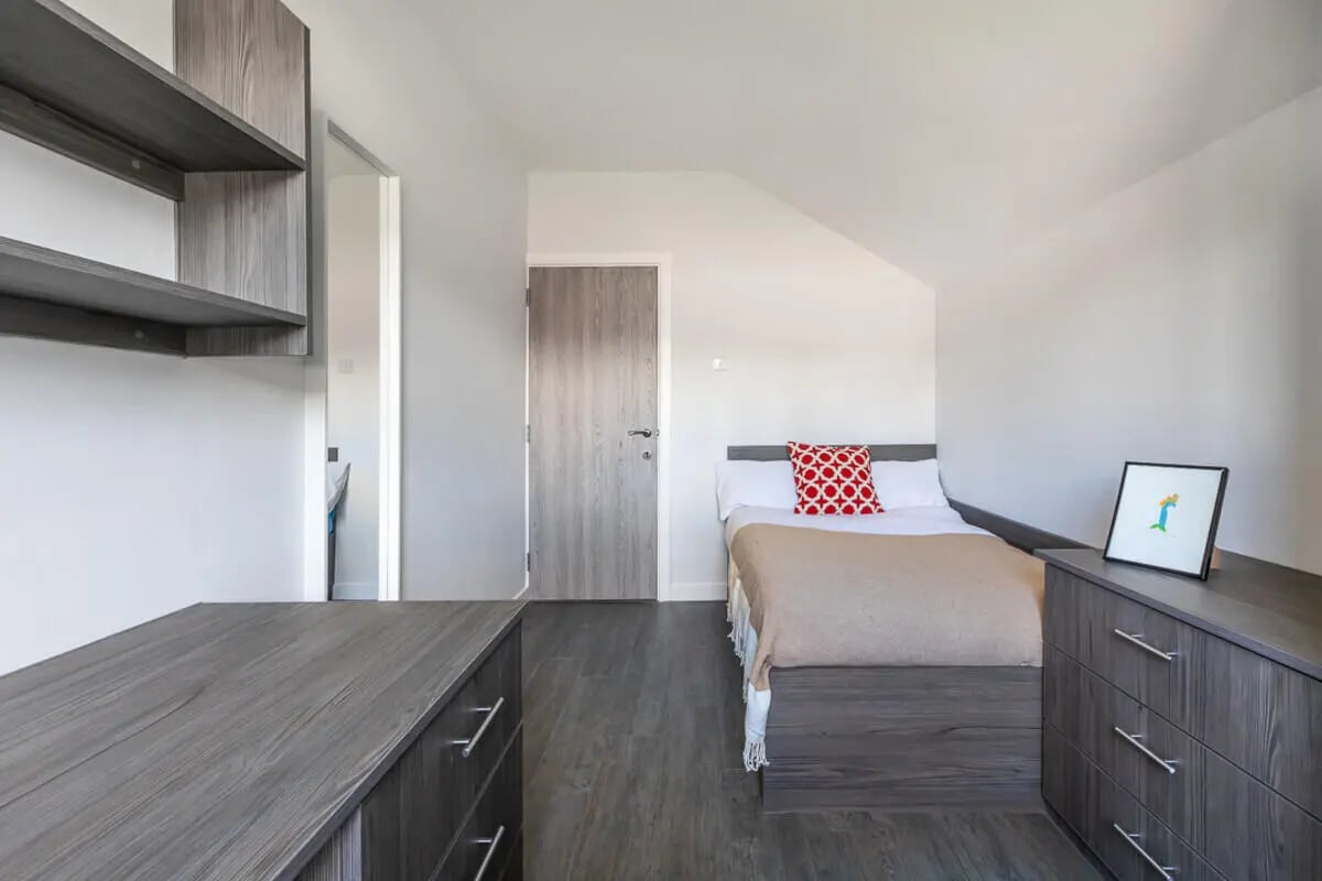 Bed dresser shelves and framed art Bedroom at Hyde Park in Leeds Student Accommodation