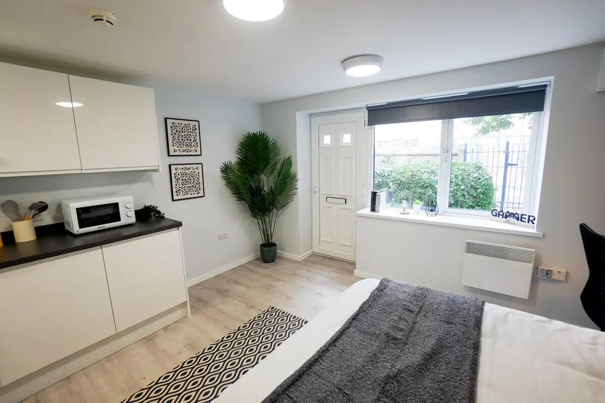 Kitchen microwave plant door window bed living area at Madison Gardens in Nottingham Student Accommodation