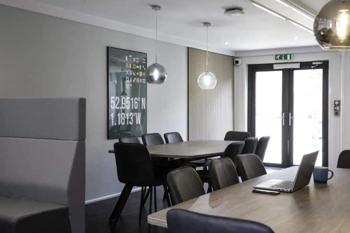 Dining tables with chairs and laptop living room at Madison Gardens in Nottingham Student Accommodation