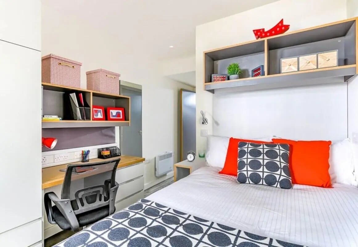 Bed desk storage boxes and chair bedroom at The Cam Foundry in Cambridge Student Accommodation
