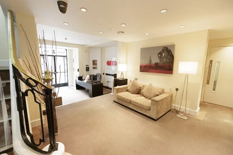 Sofa reception desk and stairs Lobby at AXO Oxford Circus in London Student Accommodation