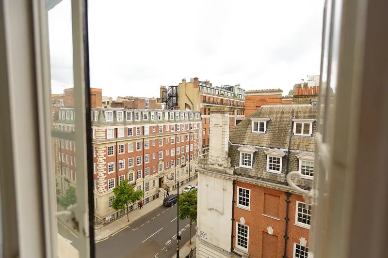 City buildings seen from an open window exterior at AXO Oxford Circus in London Student Accommodation