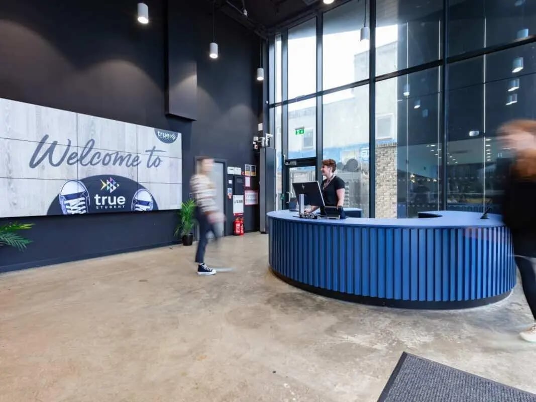 Welcome sign blue reception desk reception area at True Glasgow in Glasgow Student Accommodation